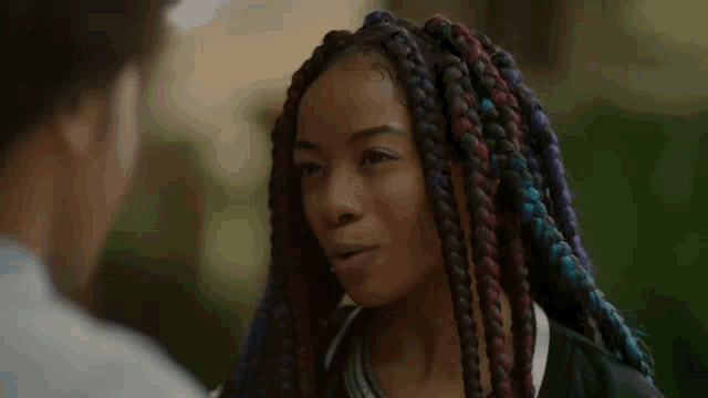 a woman with braids is talking to another woman