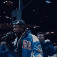 a man wearing a blue jacket with the letter b on it