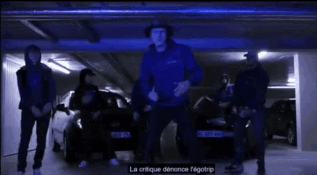 a group of men are dancing in a garage with the words lon lon lon lon lon written on the screen
