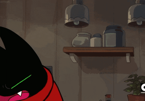 a black cat with green eyes and a red cape points at something