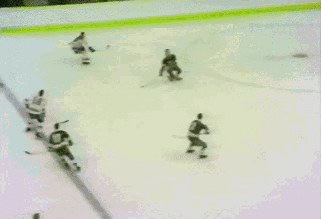 a hockey game is being played in a stadium and the goalie has the number 5 on his jersey