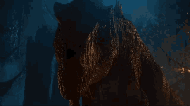 a close up of a dinosaur 's face in the dark