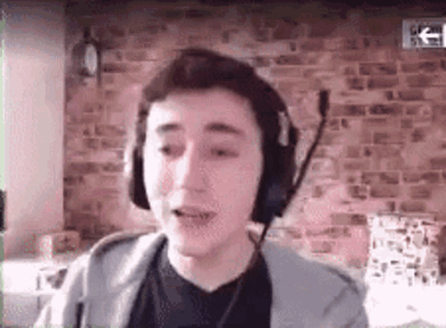 a young man wearing headphones and a microphone .