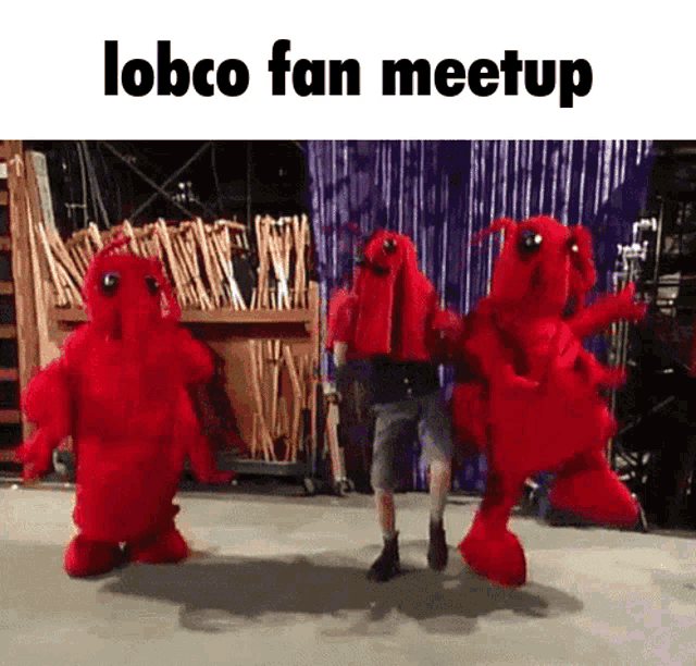a group of lobco mascots are dancing with a man