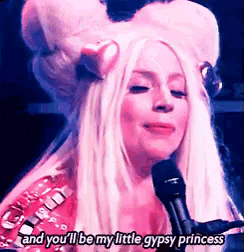 a woman singing into a microphone with the words and you 'll be my little gypsy princess