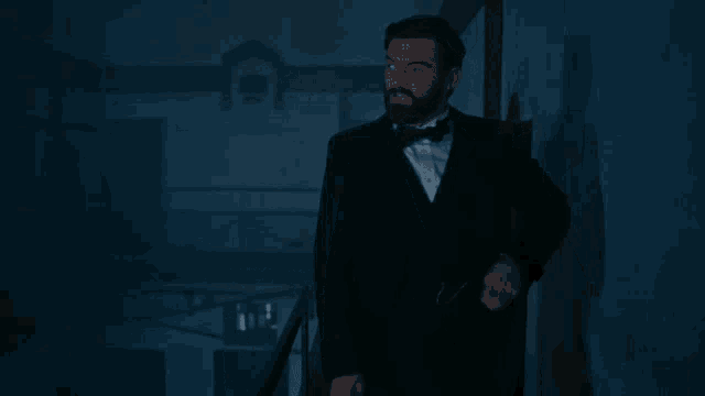 a man in a tuxedo and bow tie says " yes i 'm coming "