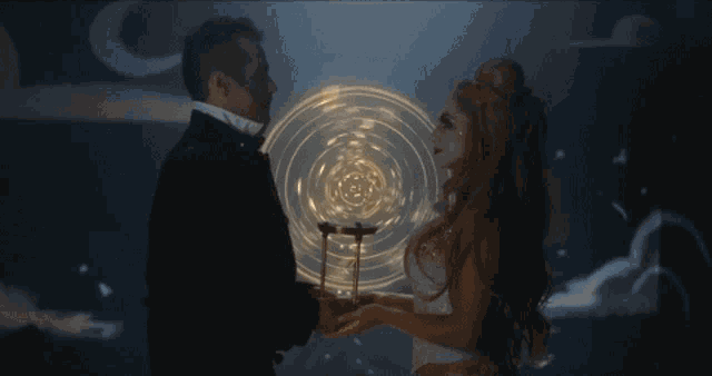 a man and woman are holding hands in front of a circle