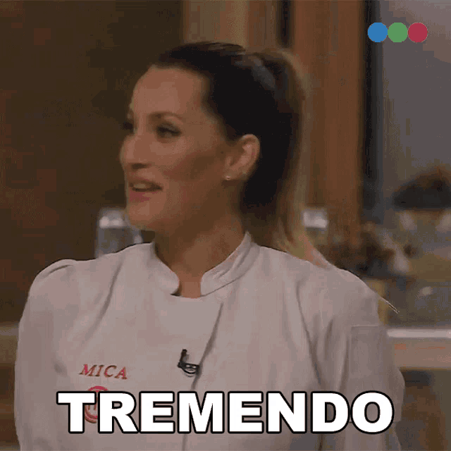 a woman in a chef 's uniform says " tremendo " in spanish