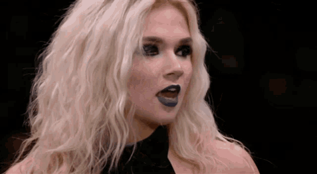 a close up of a woman with blonde hair and blue lipstick