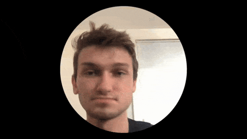a man 's face is in a circle with a black background