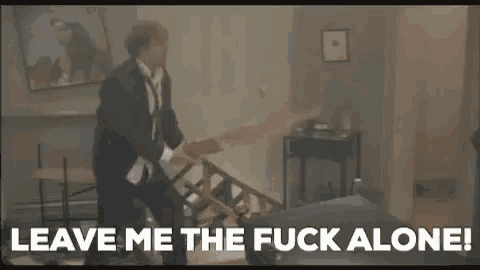 a man in a suit and tie is playing a guitar while sitting on a staircase .
