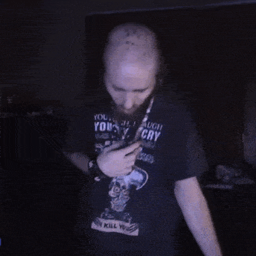 a blurry picture of a man wearing a black shirt that says ' i 'm a killer ' on it