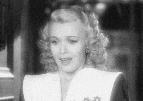 a black and white photo of a woman in a white dress