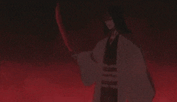 a person is standing in a dark room with a red light coming out of the ceiling .