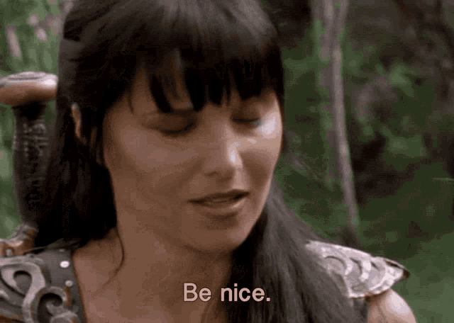 a woman with a sword says " be nice " in front of her