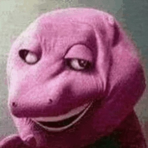a close up of a purple dinosaur with a big smile on his face .
