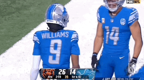 a football player wearing a number 9 jersey stands next to a player wearing a number 14 jersey