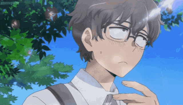 a boy with glasses is standing in front of a tree with a blue sky in the background