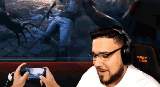 a man wearing glasses and headphones is playing a game