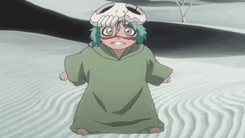 a little girl with a skull on her head is kneeling in the sand