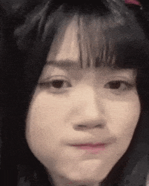 a close up of a woman 's face with a funny face .
