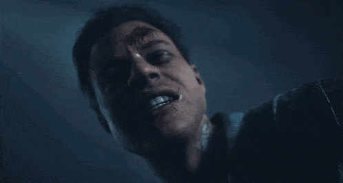 a close up of a man 's face with blood on his face .