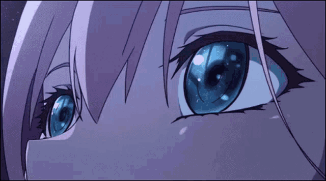 a close up of a girl 's blue eyes with a pink hair