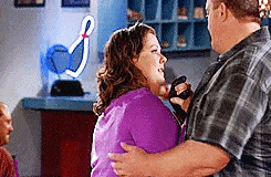 a man and a woman are dancing in a room .