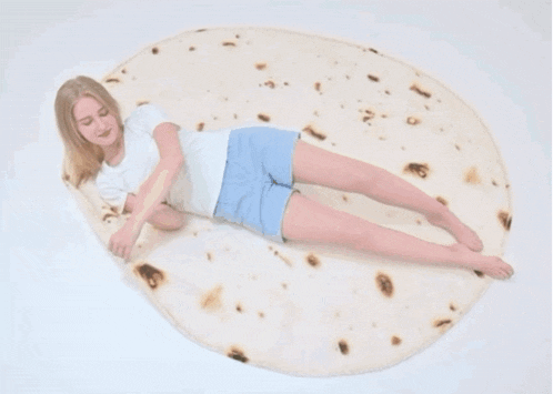 a woman wrapped in a burrito blanket with the words " you will be a real burritos "