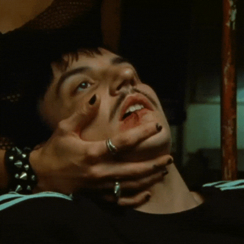 a close up of a person holding another person 's neck with a ring on their finger