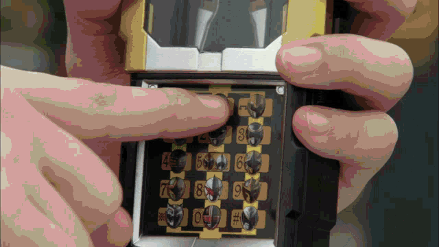 a person is holding a device that has numbers on it including 4 5 6 7 8 and 9