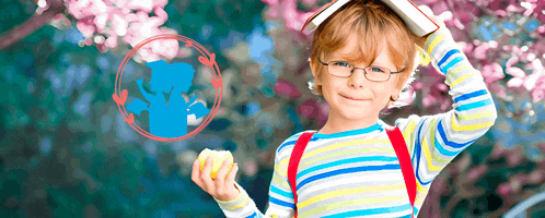 a young boy with glasses and a book on his head holds an apple