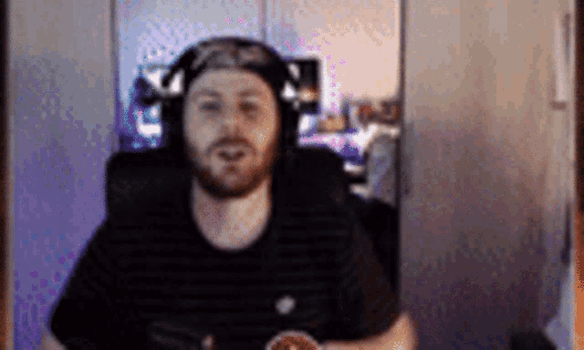 a man with a beard wearing headphones and a hat