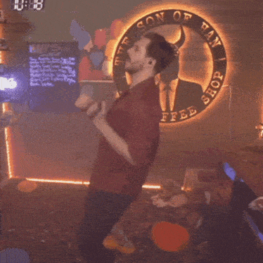 a man is dancing in front of the son of han coffee shop