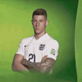 a man with a tattoo on his arm is wearing a white jersey with the number 21 on it