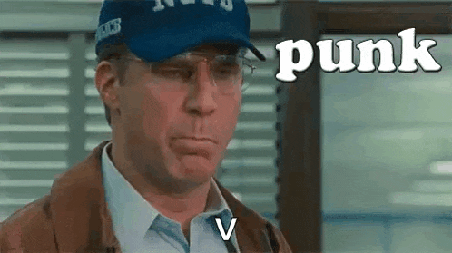 a man wearing a blue hat and glasses is making a face .