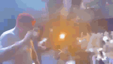 a blurry picture of a man holding a microphone in front of a crowd