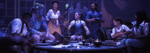 a group of people sitting around a table with a man holding a green glowing object in the middle