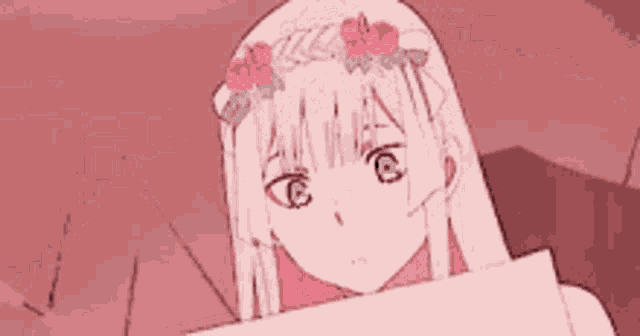 a girl with a flower in her hair is holding a piece of paper .
