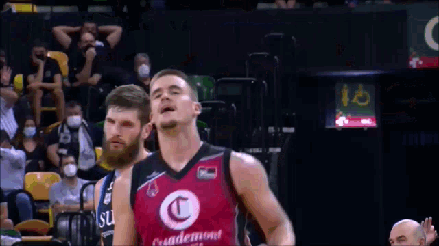 a basketball player wearing a casademont jersey is celebrating