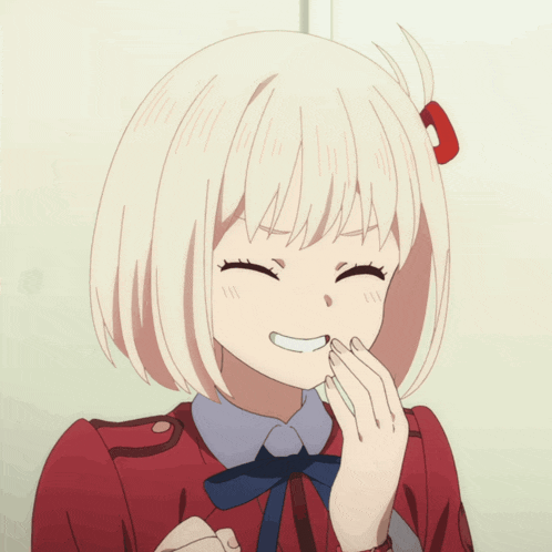 a girl with blonde hair and a red dress smiles