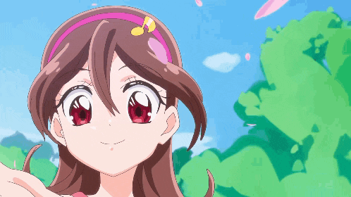 a girl with red eyes and a pink headband is smiling