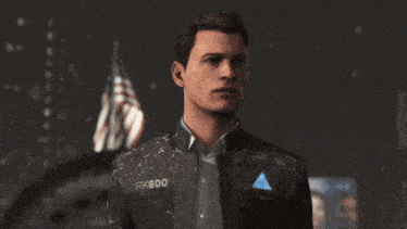 a man in a suit is standing in front of a crowd .