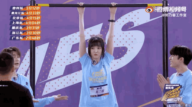 a girl in a blue shirt that says skechers hangs upside down