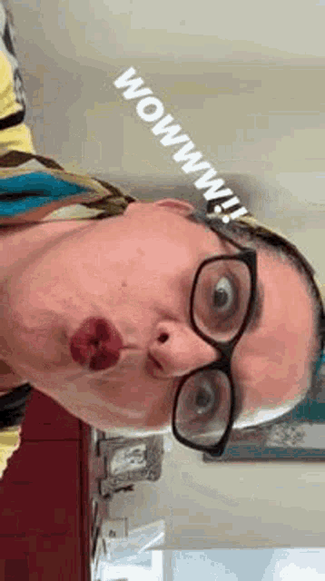 a woman wearing glasses and making a funny face with her mouth open .