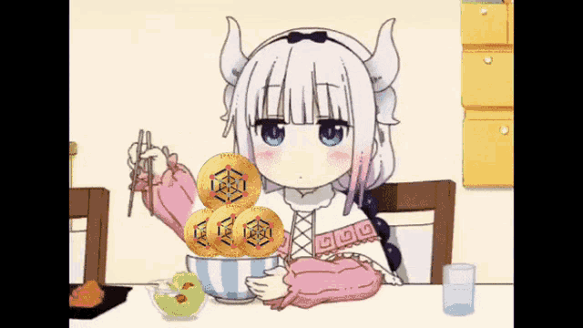 a girl with horns is sitting at a table with a bowl of food and chopsticks .