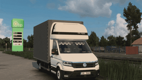 a white volkswagen truck is parked in front of a bp gas station