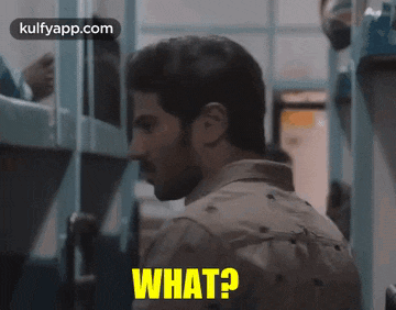 a man is sitting on a train and says what