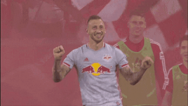 a soccer player wearing a grey jersey with the number 77 on it