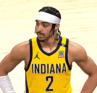 a man wearing a yellow indiana jersey number 2